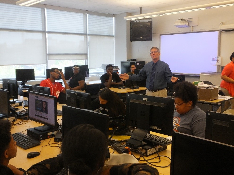 Gregory Laidlaw discussing his career in a classroom full of students at Cyber Career Day 2