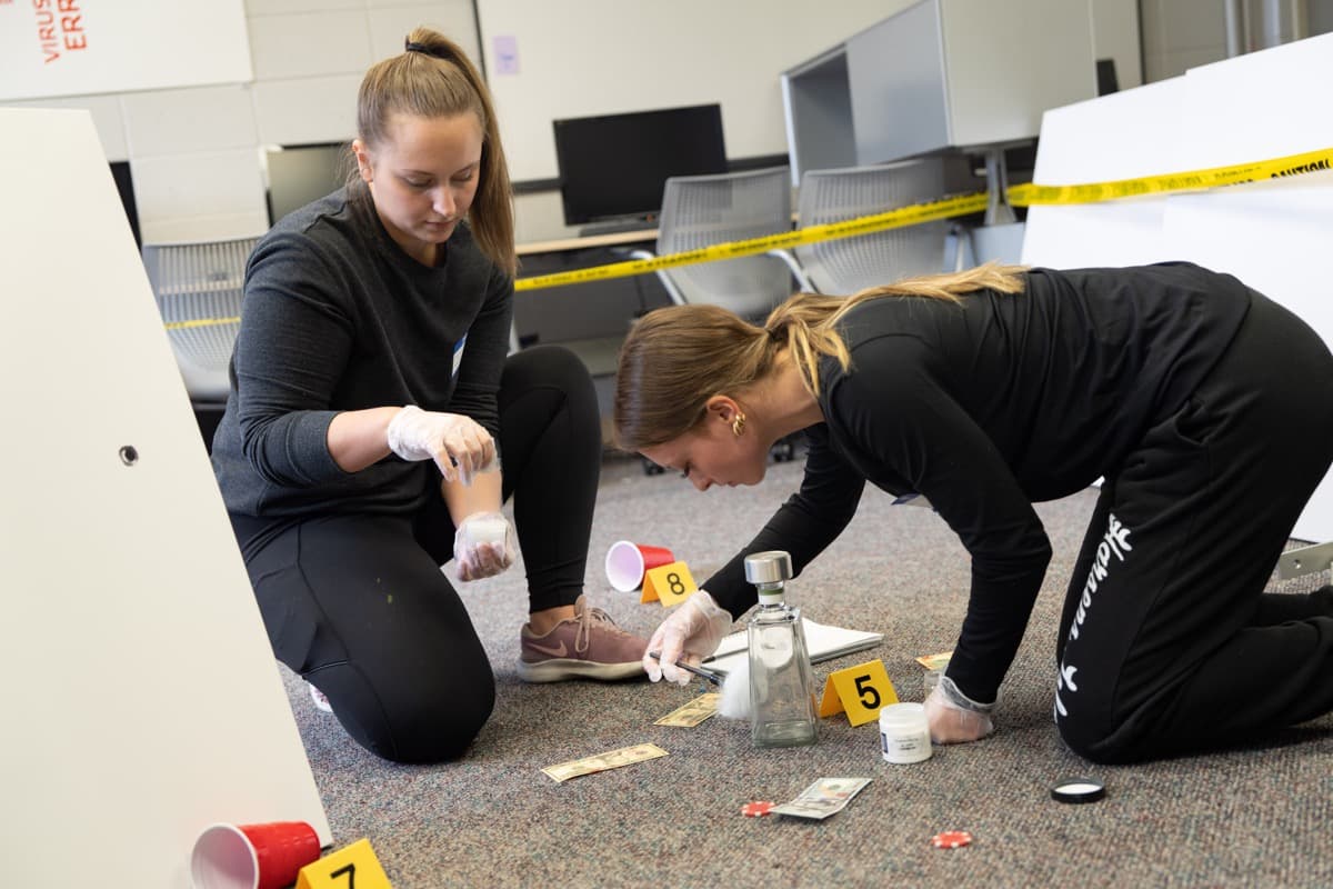 Two students dusting for fingerprints