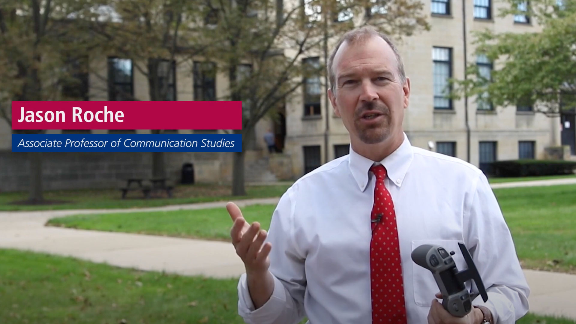 Jason Roche, Associate Professor of Communication Studies holding a controller for a drone