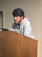 Prasad Jadhav standing at a podium