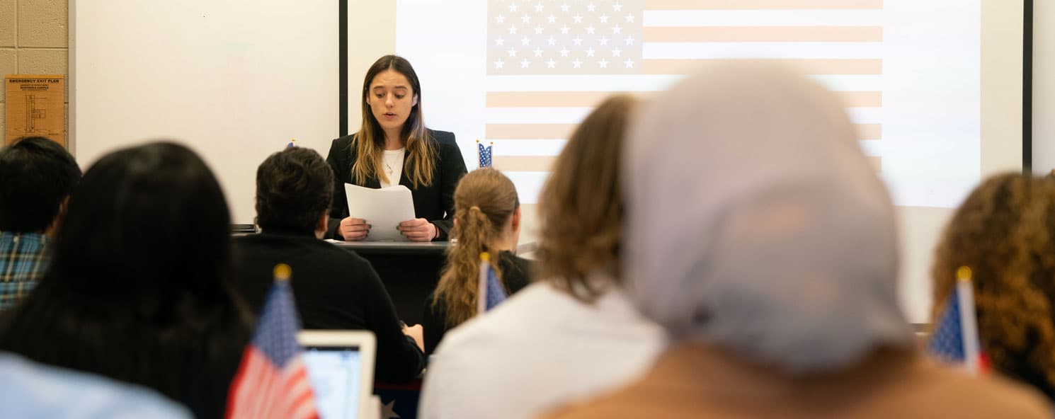 Female student presenting a court case in front of classroom