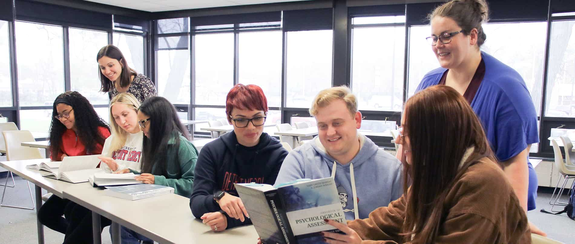 Master's level clinical psychology students in small groups with faculty instructors