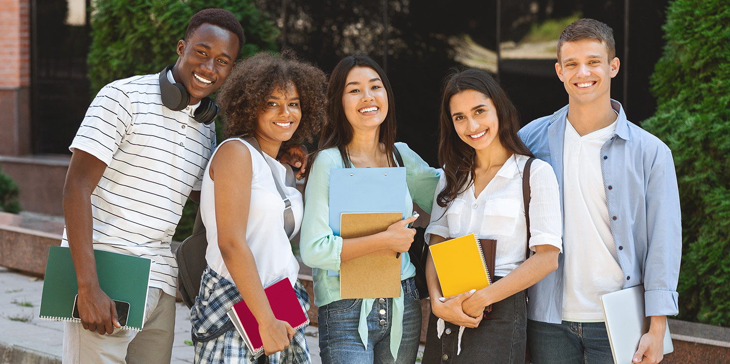 Men and women college students standing together smiling