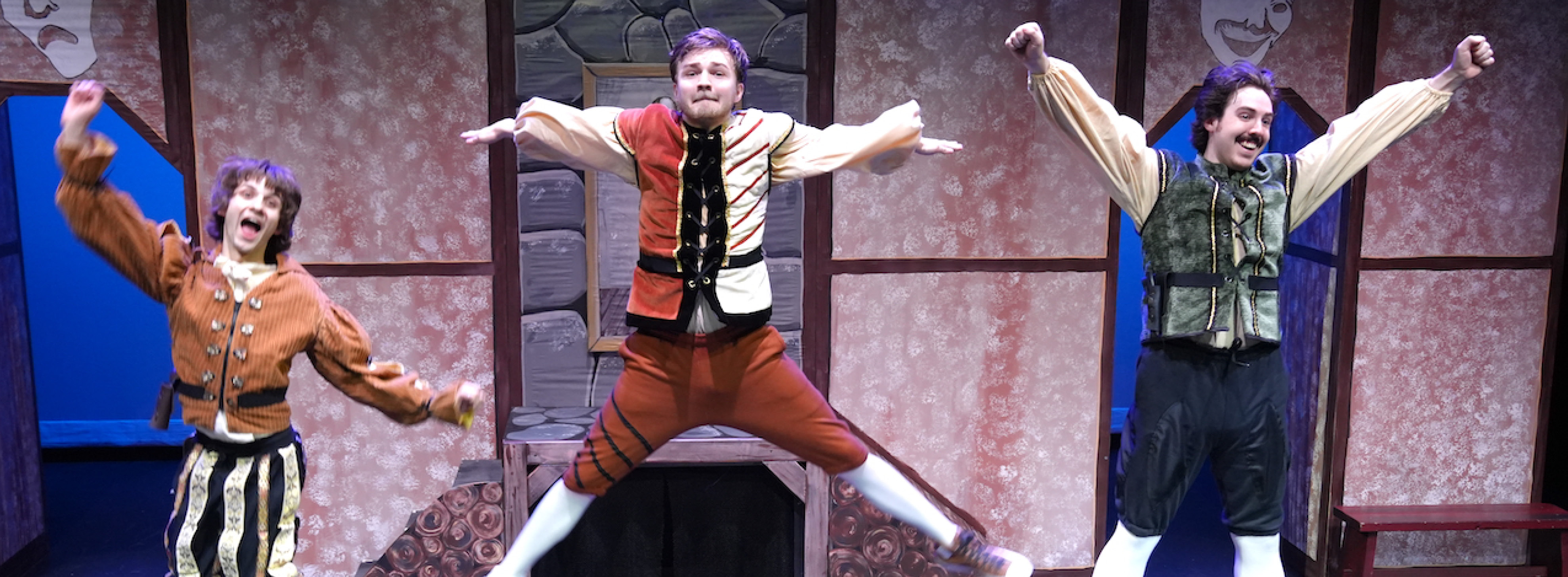 Three actors jump in the air
